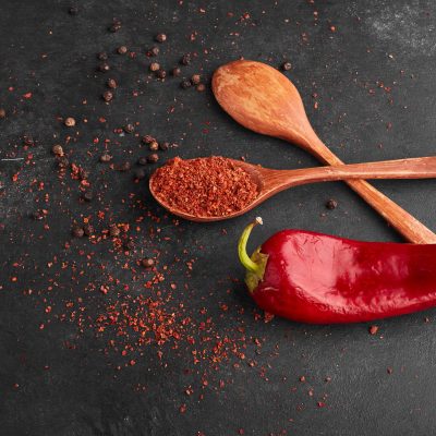 Red chili pepper with paprika in a wooden spoon. High quality photo